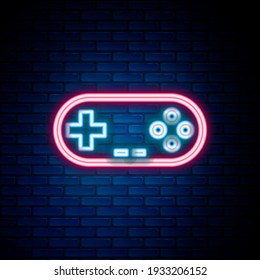 Glowing neon line Gamepad icon isolated on brick wall background. Game controller. Colorful outline concept. Vector