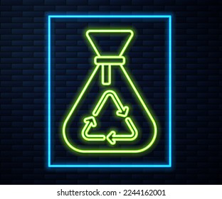 Glowing neon line Garbage bag with recycle symbol icon isolated on brick wall background. Trash can icon. Recycle basket sign.  Vector