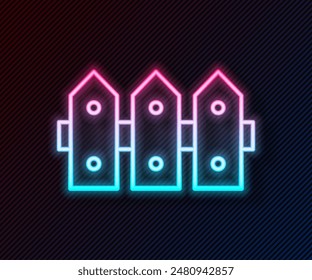 Glowing neon line Garden fence wooden icon isolated on black background.  Vector