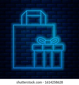 Glowing neon line Gift box icon isolated on brick wall background.  Vector Illustration