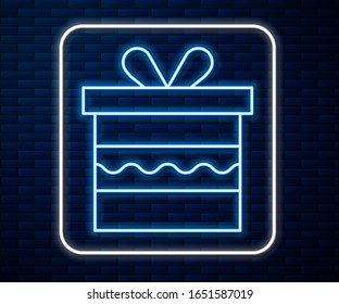 Glowing neon line Gift box icon isolated on brick wall background. Happy Birthday.  Vector Illustration