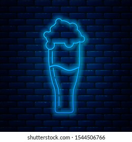 Glowing neon line Glass of beer icon isolated on brick wall background.  Vector Illustration