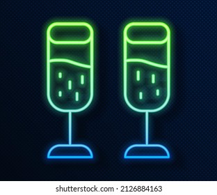 Glowing neon line Glass of champagne icon isolated on blue background. Merry Christmas and Happy New Year.  Vector