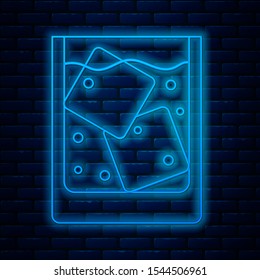 Glowing neon line Glass of whiskey and ice cubes icon isolated on brick wall background.  Vector Illustration