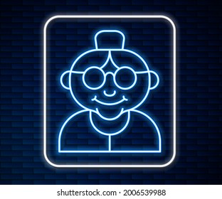 Glowing neon line Grandmother icon isolated on brick wall background.  Vector