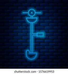 Glowing neon line Grass and weed electric string trimmer icon isolated on brick wall background. Grass clipper, lawn mower isolated on white background.  Vector Illustration