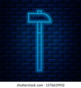 Glowing neon line Hammer icon isolated on brick wall background. Tool for repair.  Vector Illustration