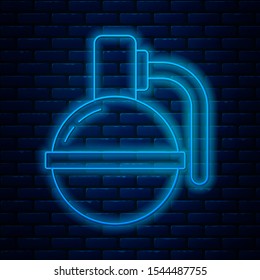 Glowing neon line Hand grenade icon isolated on brick wall background. Bomb explosion.  Vector Illustration