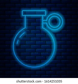 Glowing neon line Hand grenade icon isolated on brick wall background. Bomb explosion.  Vector Illustration