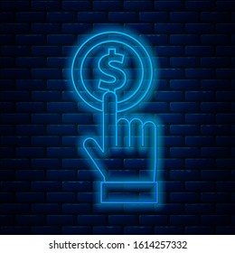 Glowing neon line Hand holding coin icon isolated on brick wall background. Dollar or USD symbol. Cash Banking currency sign.  Vector Illustration