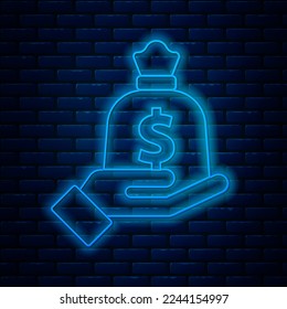 Glowing neon line Hand holding money bag icon isolated on brick wall background. Dollar or USD symbol. Cash Banking currency sign.  Vector