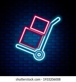 Glowing neon line Hand truck and boxes icon isolated on brick wall background. Dolly symbol. Colorful outline concept. Vector