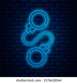 Glowing neon line Handcuffs icon isolated on brick wall background.  Vector Illustration