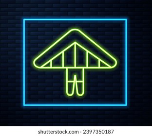 Glowing neon line Hang glider icon isolated on brick wall background. Extreme sport.  Vector Illustration