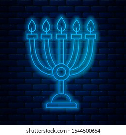 Glowing neon line Hanukkah menorah icon isolated on brick wall background. Hanukkah traditional symbol. Holiday religion, jewish festival of Lights.  Vector Illustration