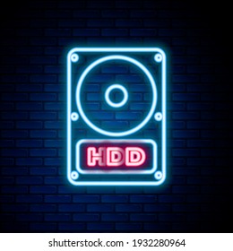 Glowing neon line Hard disk drive HDD icon isolated on brick wall background. Colorful outline concept. Vector