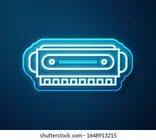 Glowing neon line Harmonica icon isolated on blue background. Musical instrument.  Vector Illustration