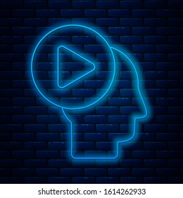 Glowing neon line Head people with play button icon isolated on brick wall background.  Vector Illustration