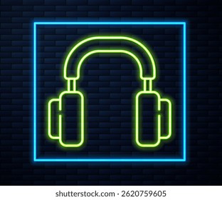 Glowing neon line Headphones icon isolated on brick wall background. Earphones. Concept for listening to music, service, communication and operator.  Vector