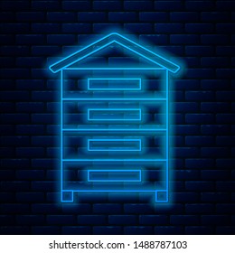 Glowing neon line Hive for bees icon isolated on brick wall background. Beehive symbol. Apiary and beekeeping. Sweet natural food.  Vector Illustration