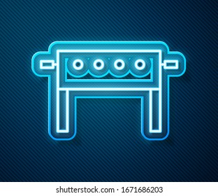 Glowing neon line Hockey table icon isolated on blue background.  Vector Illustration