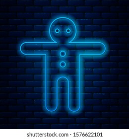 Glowing neon line Holiday gingerbread man cookie icon isolated on brick wall background. Cookie in shape of man with icing.  Vector Illustration