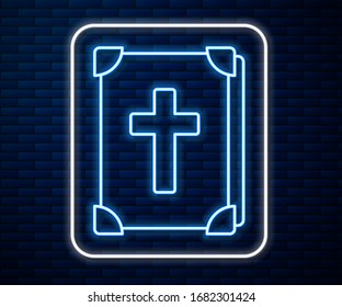 Glowing neon line Holy bible book icon isolated on brick wall background.  Vector Illustration