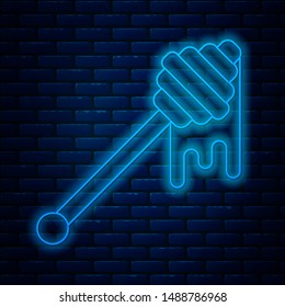 Glowing neon line Honey dipper stick with dripping honey icon isolated on brick wall background. Honey ladle.  Vector Illustration