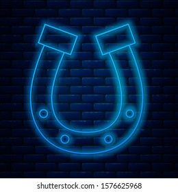 Glowing neon line Horseshoe icon isolated on brick wall background.  Vector Illustration