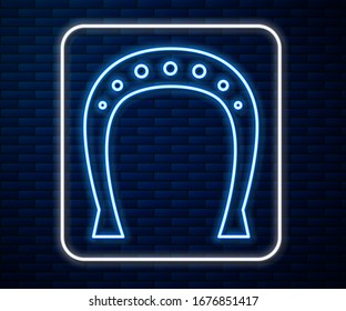 Glowing neon line Horseshoe icon isolated on brick wall background.  Vector Illustration