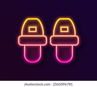 Glowing neon line Hotel slippers icon isolated on black background. Flip flops sign.  Vector