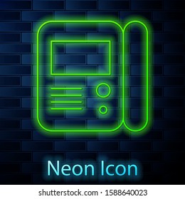 Glowing neon line House intercom system icon isolated on brick wall background.  Vector Illustration