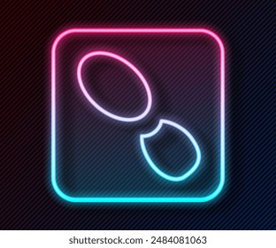 Glowing neon line Human footprints shoes icon isolated on black background. Shoes sole.  Vector