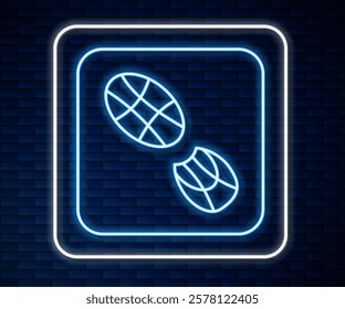 Glowing neon line Human footprints shoes icon isolated on brick wall background. Shoes sole.  Vector