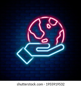 Glowing neon line Human hand holding Earth globe icon isolated on brick wall background. Save earth concept. Colorful outline concept. Vector