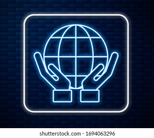 Glowing neon line Human hands holding Earth globe icon isolated on brick wall background. Save earth concept.  Vector Illustration