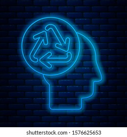 Glowing neon line Human head with recycle icon isolated on brick wall background. Recycling thinking. Ecology friendly.  Vector Illustration