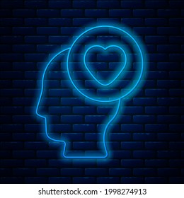 Glowing neon line Human head with heart icon isolated on brick wall background. Love concept with human head.  Vector