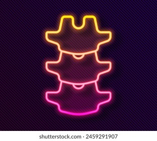 Glowing neon line Human spine icon isolated on black background.  Vector