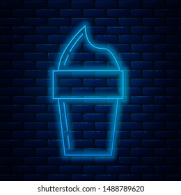 Glowing neon line Ice cream in waffle cone icon isolated on brick wall background. Sweet symbol.  Vector Illustration