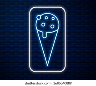 Glowing neon line Ice cream in waffle cone icon isolated on brick wall background. Sweet symbol.  Vector Illustration