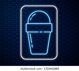 Glowing neon line Ice cream in waffle cone icon isolated on brick wall background. Sweet symbol.  Vector Illustration