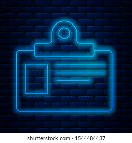 Glowing neon line Identification badge icon isolated on brick wall background. It can be used for presentation, identity of the company, advertising.  Vector Illustration