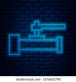 Glowing neon line Industry metallic pipes and valve icon isolated on brick wall background.  Vector Illustration