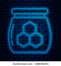 Glowing neon line Jar of honey icon isolated on brick wall background. Food bank. Sweet natural food symbol.  Vector Illustration