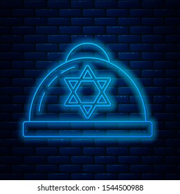 Glowing neon line Jewish kippah with star of david icon isolated on brick wall background. Jewish yarmulke hat.  Vector Illustration