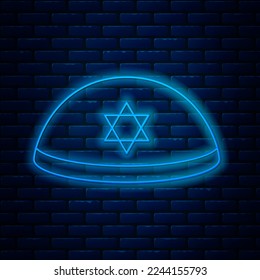 Glowing neon line Jewish kippah with star of david icon isolated on brick wall background. Jewish yarmulke hat.  Vector