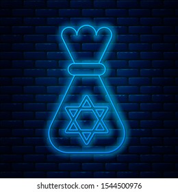 Glowing neon line Jewish money bag with star of david icon isolated on brick wall background. Currency symbol.  Vector Illustration