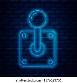 Glowing neon line Joystick for arcade machine icon isolated on brick wall background. Joystick gamepad.  Vector Illustration