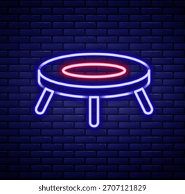 Glowing neon line Jumping trampoline icon isolated on brick wall background. Colorful outline concept. Vector